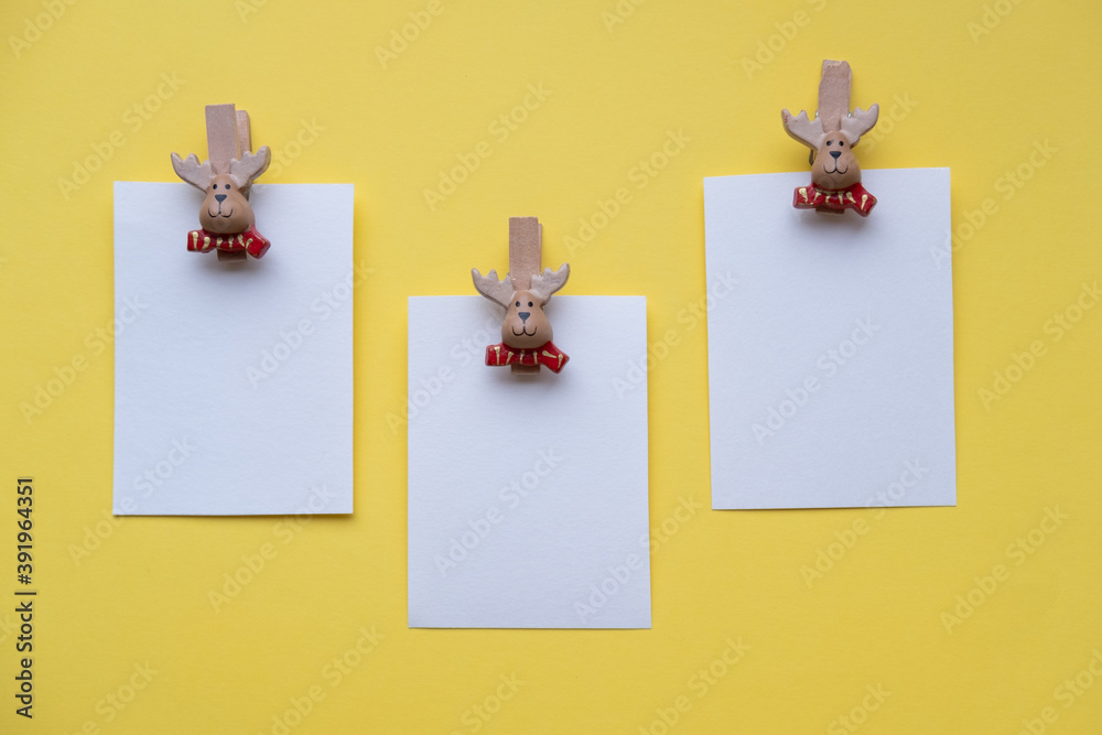 Christmas cards mockup on clothespins santa claus on a yellow background