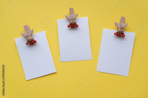 Obraz na płótnie Christmas cards mockup on clothespins santa claus on a yellow background. w salonie