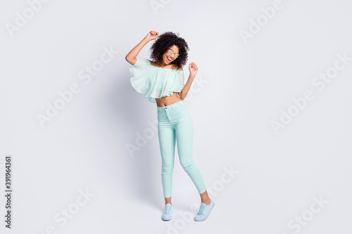 Full length body size photo of dancing girl wearing mint clothes isolated on grey color background