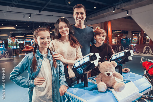 Mom and Dad brought their kids to video game room. photo