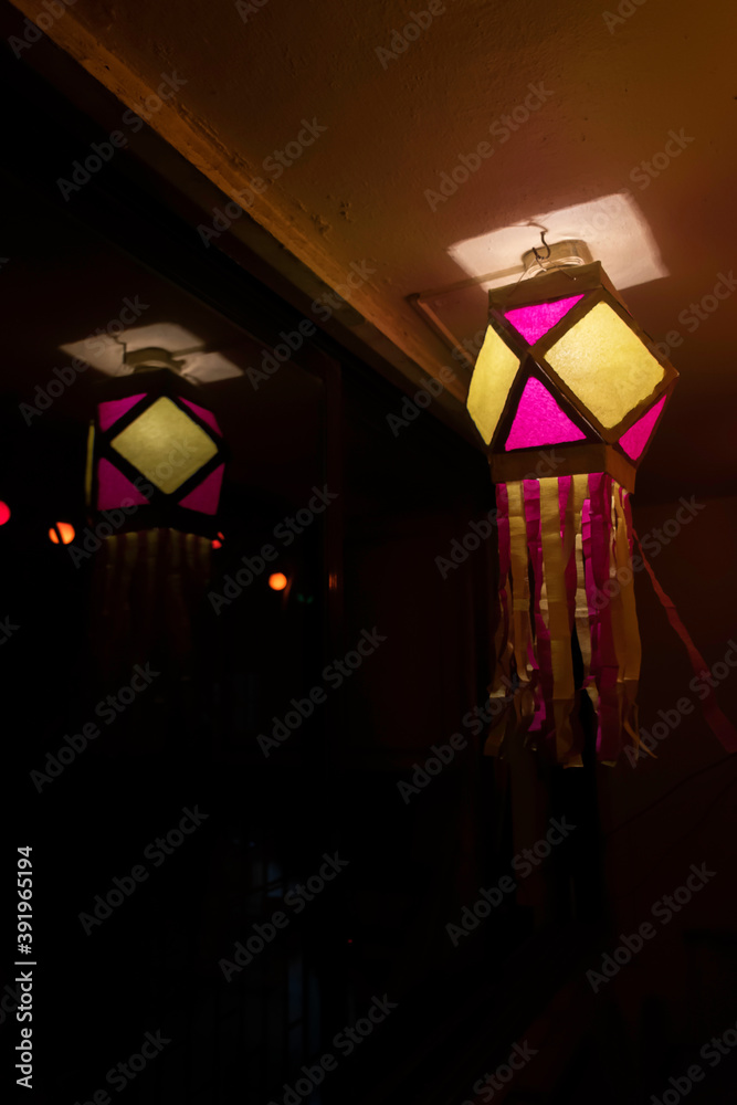 Colorful Diwali lantern or lamp hanging with reflection on the glass