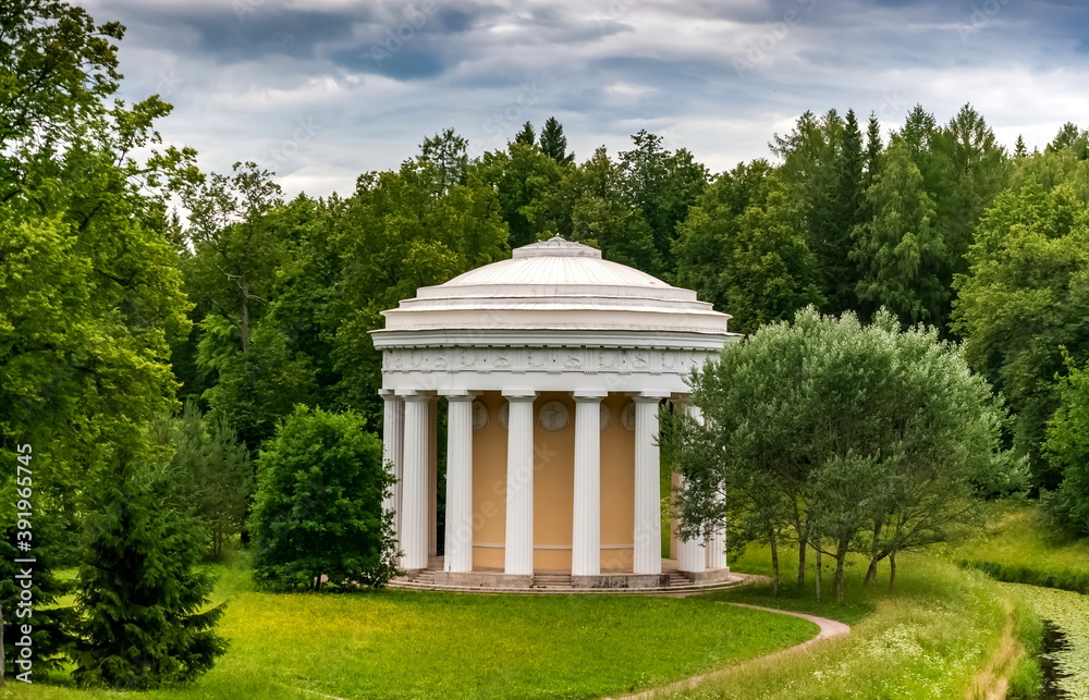 Summer landscape in a city Park with trees, pavilion, sky with clouds