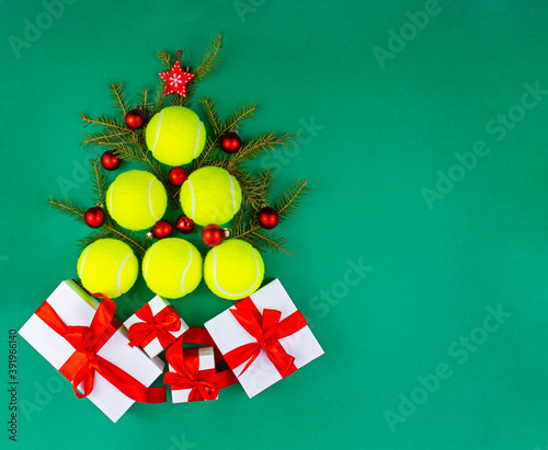 Yellow tennis balls making a shape of christmas tree with presents. Xmas and New year concept. Top view. Flat lay