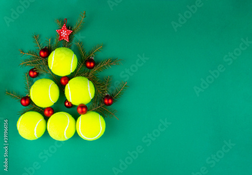 Yellow tennis balls making a shape of christmas tree. Xmas and New year concept. Top view. Flat lay