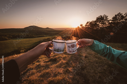camping on the hill with cups of coffee