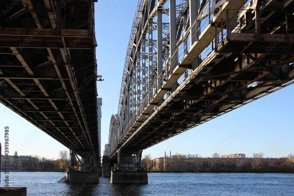 Fototapeta premium Arched spans of the rilway double-track bridge. The view from under the bridge