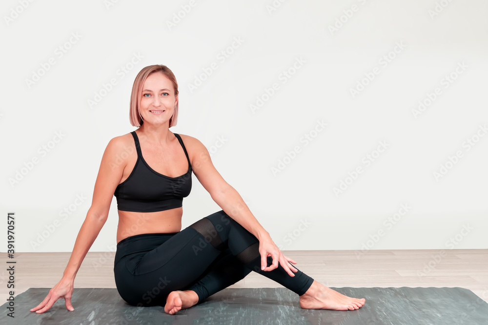 Athletic middle aged woman doing exercises..Hatha yoga Athletic middle aged woman doing exercises..Hatha yoga