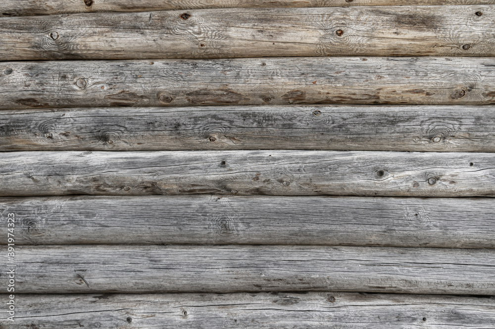 Wooden wall from logs of pine as a background texture Wooden wall from logs of pine as a background texture