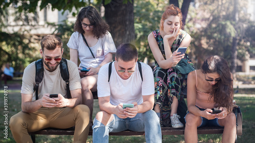 Group of friends using smartphones together. Young people addiction to new technology trends. Youth, new generation internet friendship concept. Emotional isolation and depresion