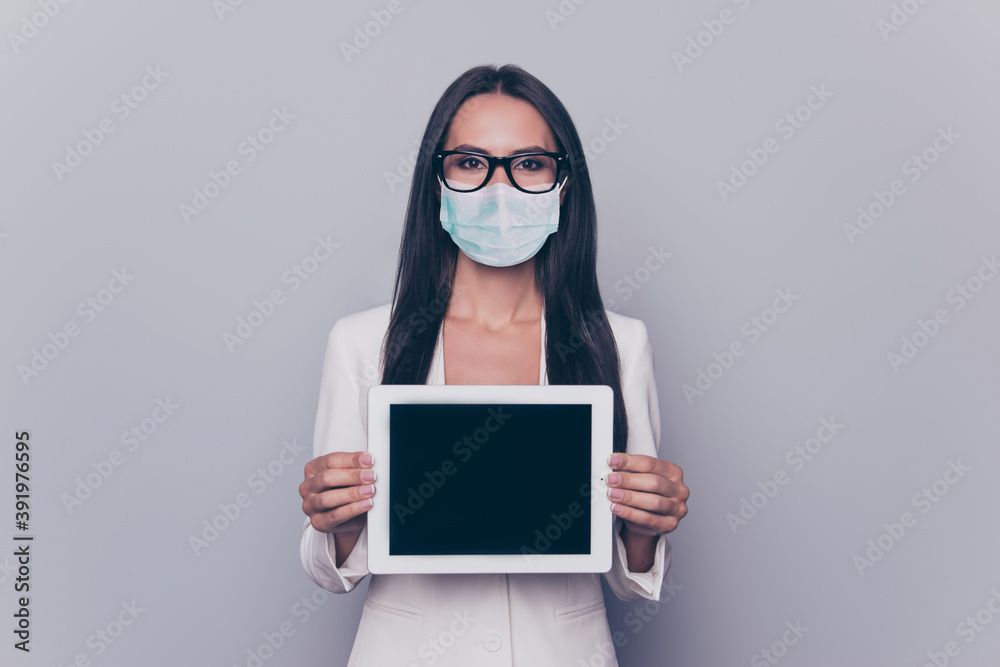 Photo portrait of woman in blue face mask showing tablet with blank space isolated on white colored background