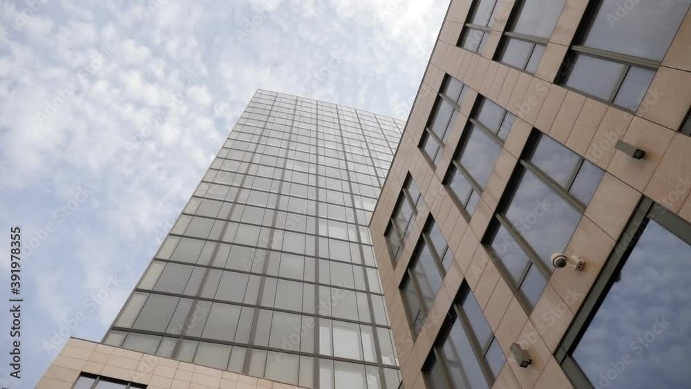 High modern building in the city with large Windows. Modern business center. High modern building in the city with large Windows. Modern business center.