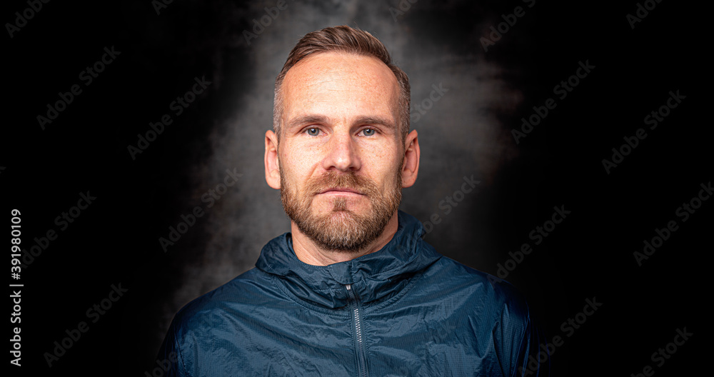 Handsome stylish man standing posing over dark background Handsome stylish man standing posing over dark background