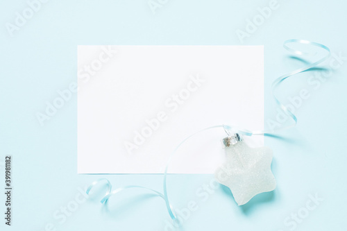 Blank card and christmas star on blue background