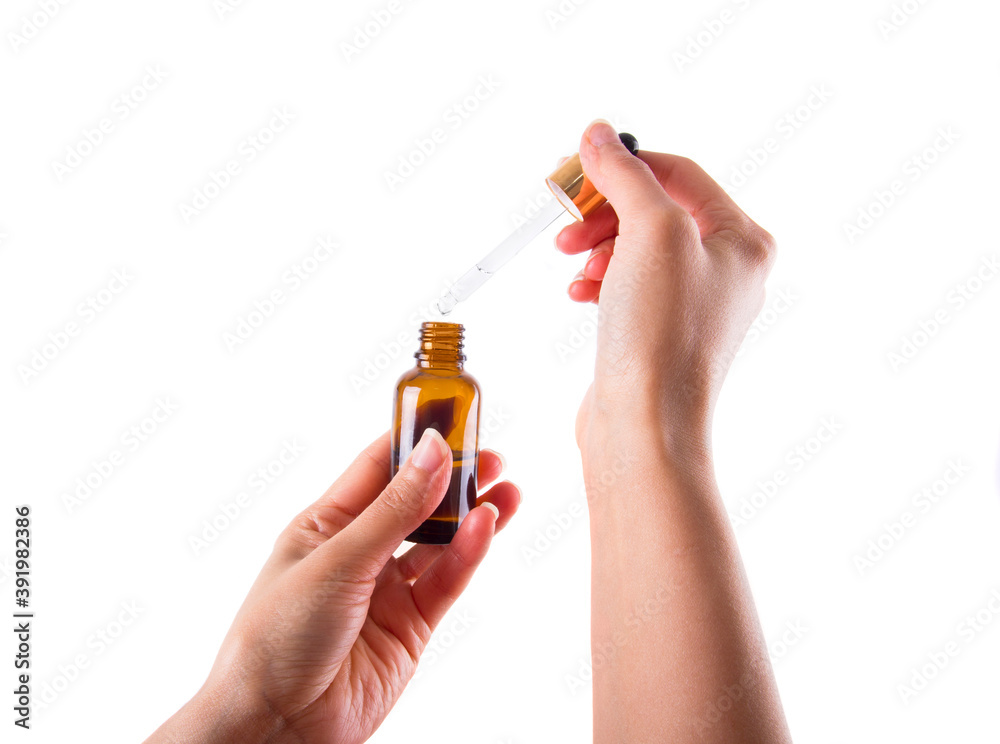 Woman hand hold serum dropper. Haircare routine. Woman hand hold serum dropper. Haircare routine.