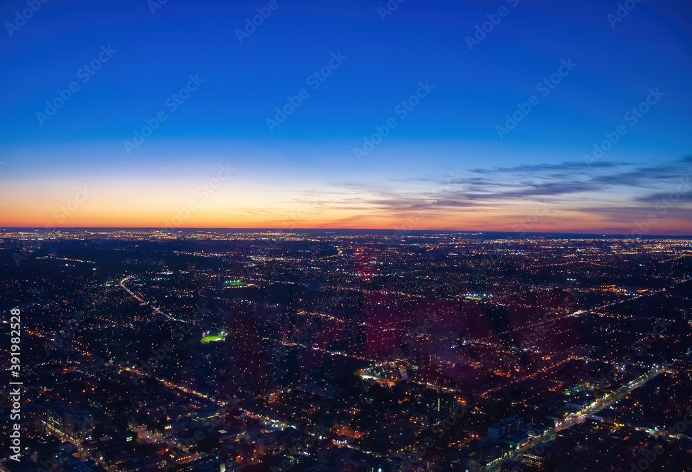 Aerial view of city skyline at dusk. Sunset sky colors
