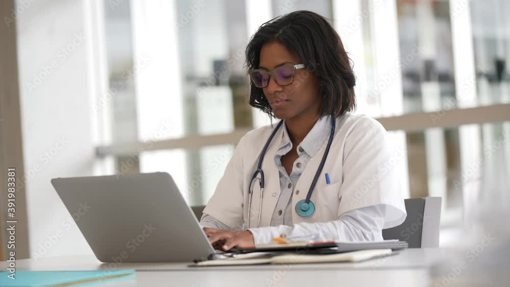 Woman doctor working in office with laptop computer Woman doctor working in office with laptop computer