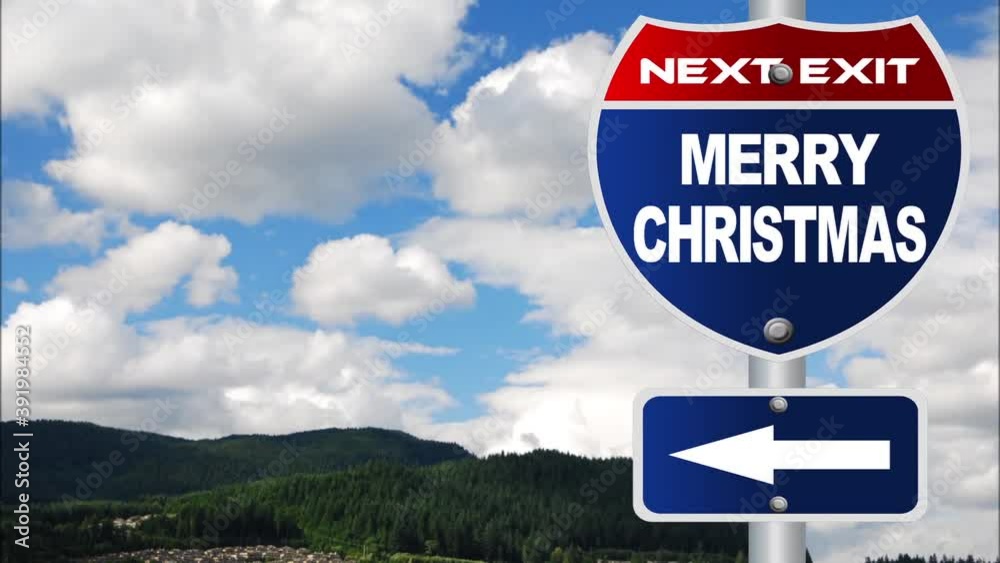 Merry Christmas road sign with time-lapse cloud background Merry Christmas road sign with time-lapse cloud background