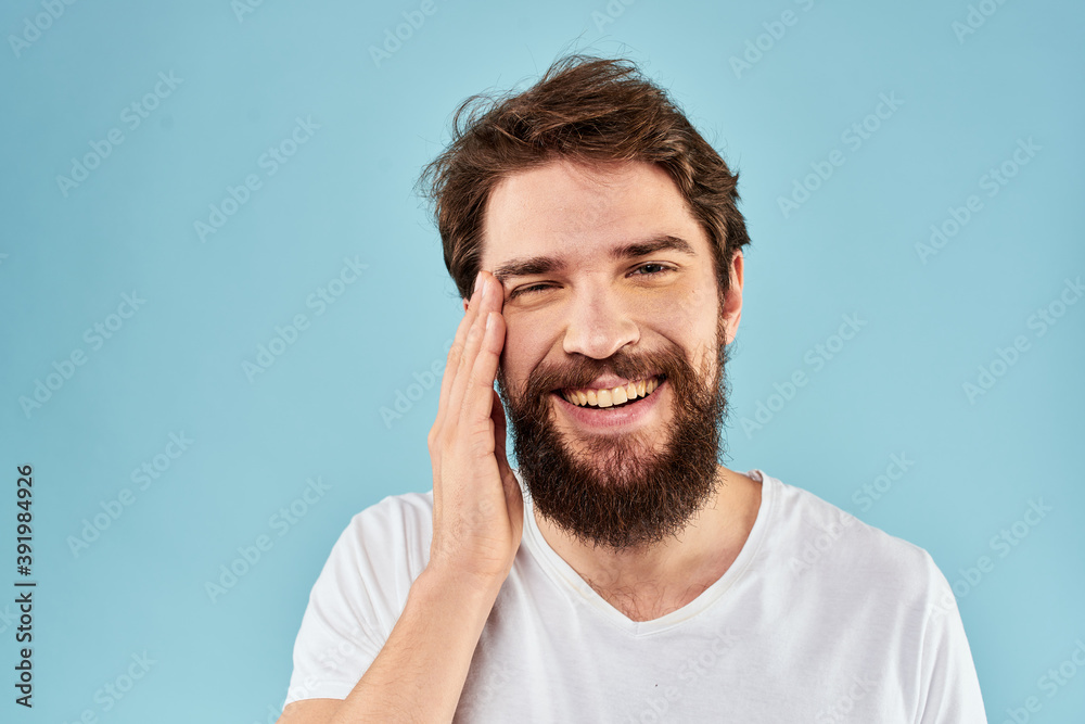 Cheerful man gesturing with his hands emotions cropped view on blue background studio Cheerful man gesturing with his hands emotions cropped view on blue background studio
