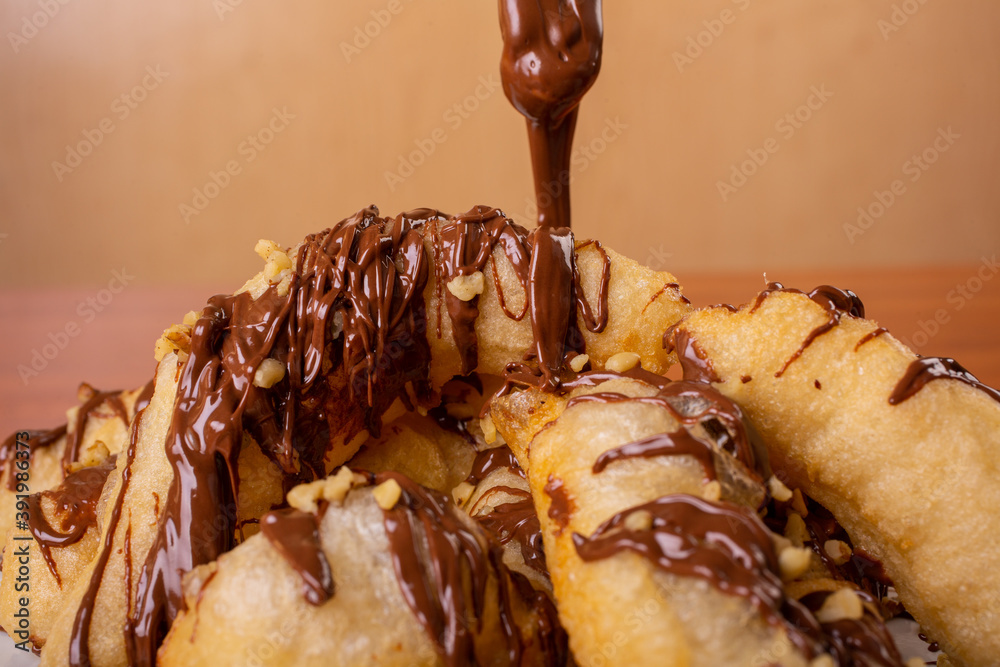 Straccetti di pizza fritti e conditi con nutella e granella di nocciole  Stock Photo | Adobe Stock