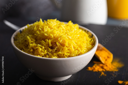 Bowl of yellow rice cooked from basmati rice with turmeric powder