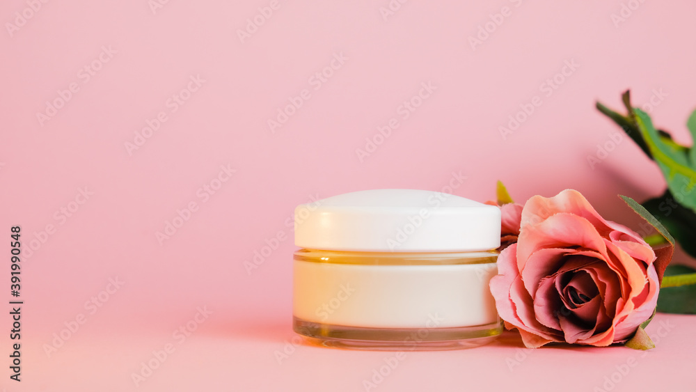 Cream jar and rose flower on pink background. Beauty product, cosmetics for skin care. Cream jar and rose flower on pink background. Beauty product, cosmetics for skin care.