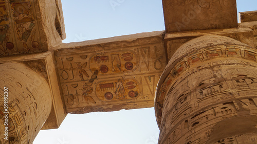 Giant columns of Karnak temple overscale architect with beautiful painting and hieroglyphic carving details photo