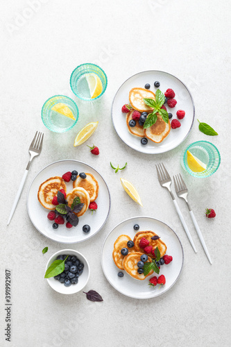 Pancakes with fresh blueberry and raspberry served for healthy vegetarian breakfast
