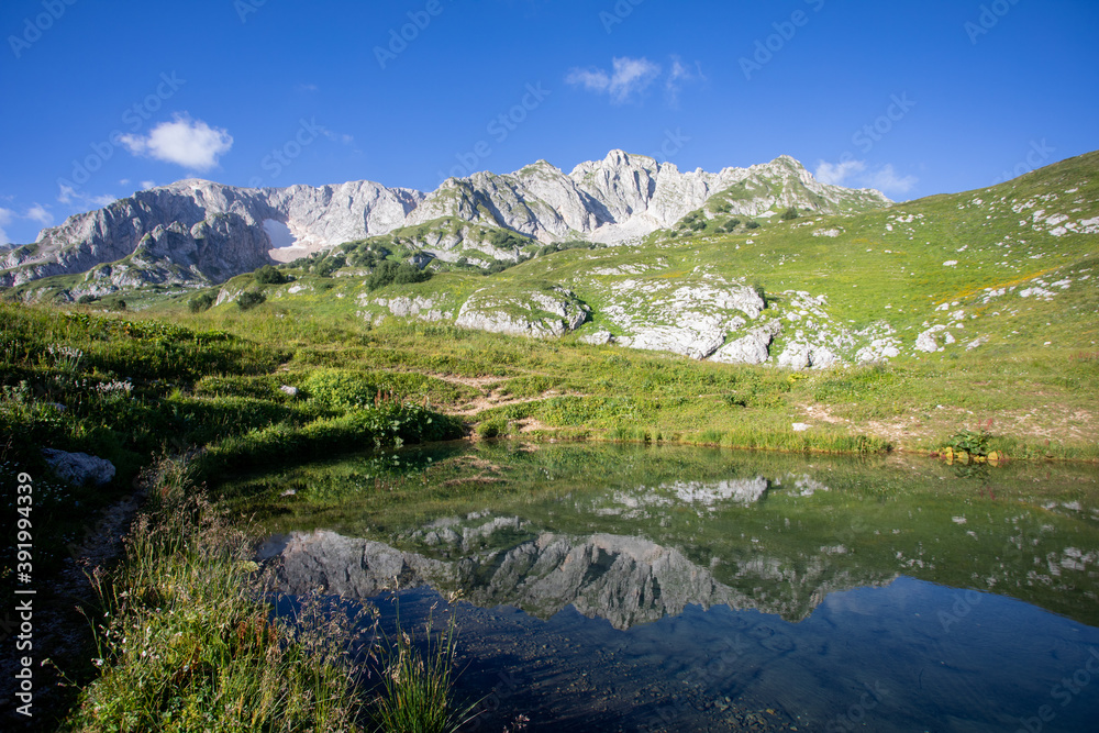 Mountain lake. Mountain peaks are reflected in the water