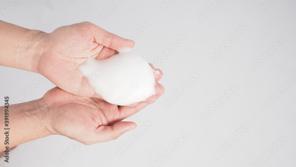 Hands washing gesture with foaming hand soap on white background. Hands washing gesture with foaming hand soap on white background.