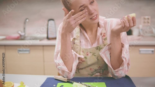 Young woman crying from chopped onion