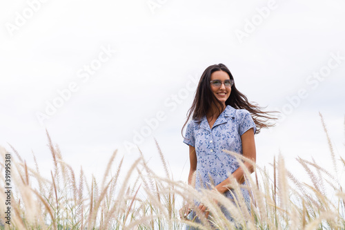 Portrait of sensetive romantic woman wearing cute blue dress on wheat field.  photo