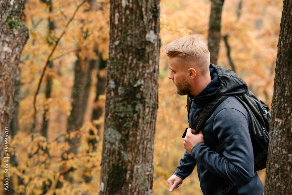 Guy tourist walks in a foggy autumn forest Guy tourist walks in a foggy autumn forest