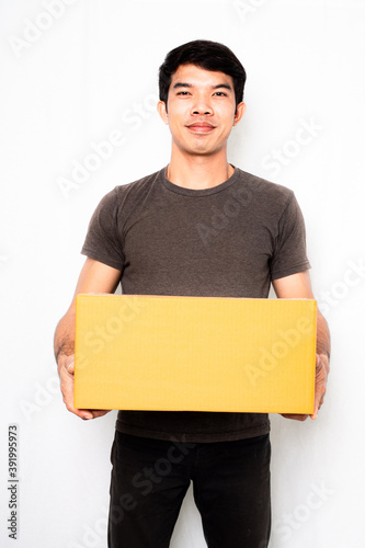 Asia men ,Thai men wearing gray t-shirts and black jeans standing lifting boxes on a white background ,Delivery worker concept