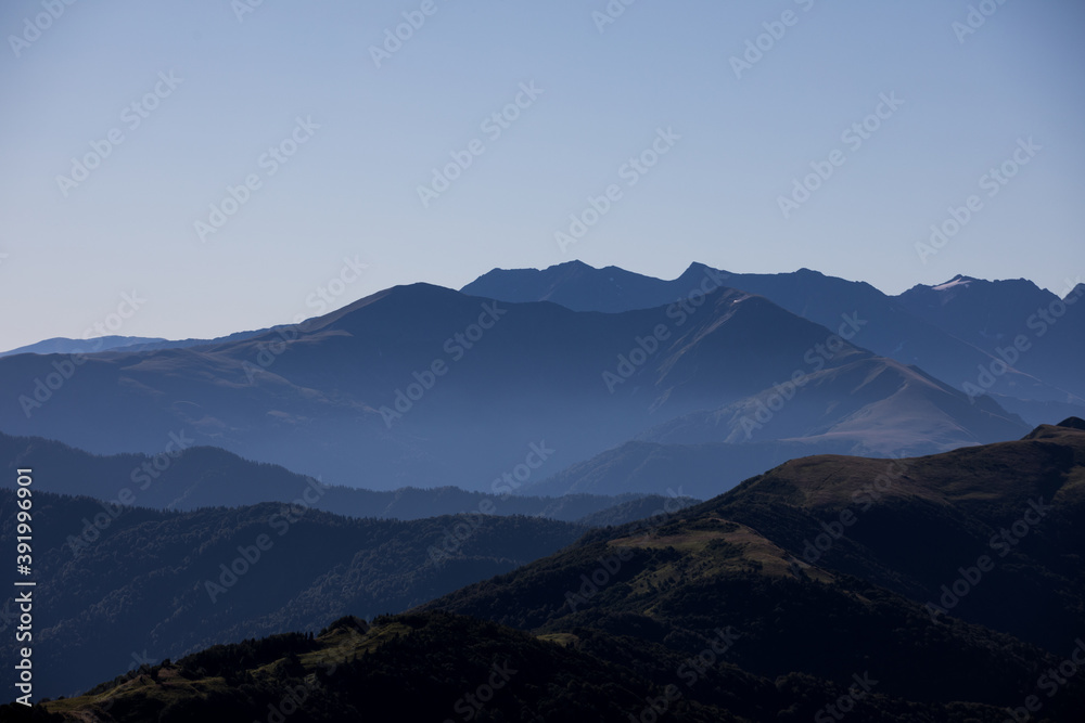 View of endless mountain ranges in the haze of the day View of endless mountain ranges in the haze of the day