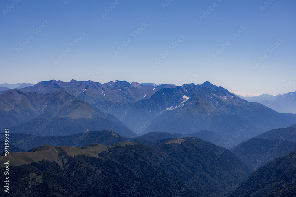 View of endless mountain ranges in the haze of the day View of endless mountain ranges in the haze of the day
