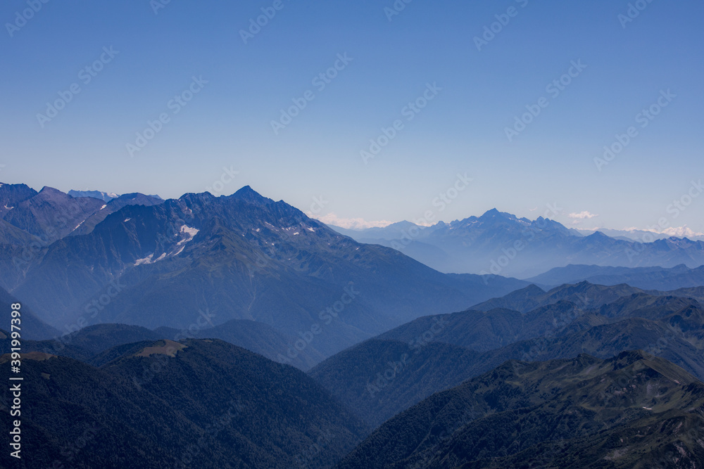 View of endless mountain ranges in the haze of the day View of endless mountain ranges in the haze of the day