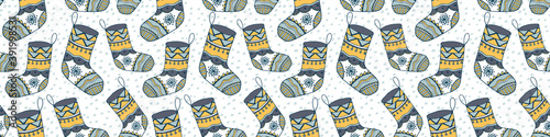 Hygge Christmas stocking vector seamless pattern. Festive decorative illustration with doodle hand drawn sock in calm winter palette for wrapping paper, wallpaper, textile