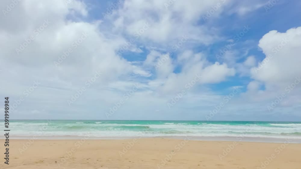 timelapse of beach with clouds in bright sunny day clear blue sky in summer time. sea foam wave clashing the shore. paradise in nature, travel in tropical country. timelapse of beach with clouds in bright sunny day clear blue sky in summer time. sea foam wave clashing the shore. paradise in nature, travel in tropical country.