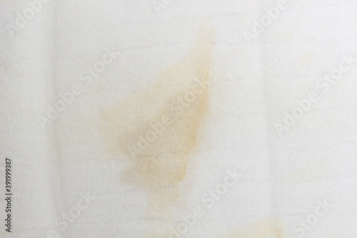 White old pillow with dirty stain. Selective focus