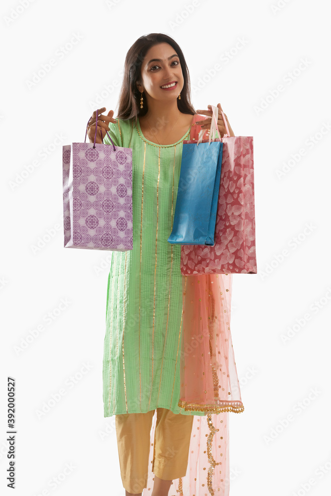 Woman excitedly  holding shopping bags	