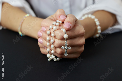 Fotografie Spiritual prayer to god, with verve or rosary in the hands of a young girl