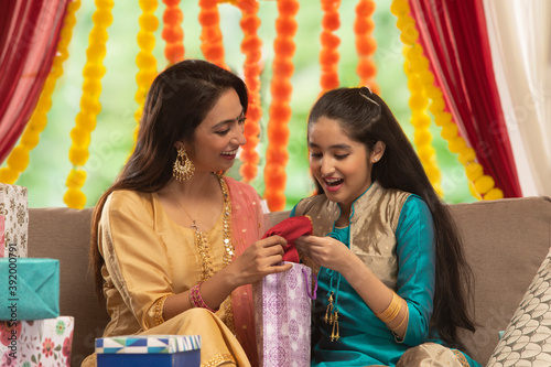 mother and daughter opening gifts together 