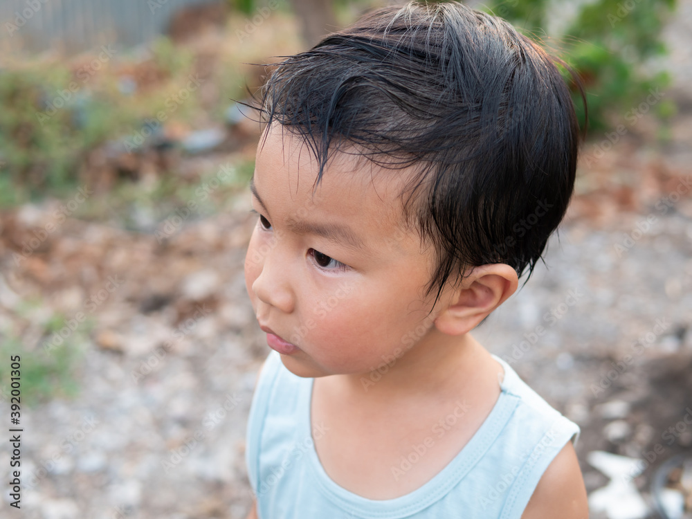 Asian cute child boy face with sweat on hair while playing outdoor. Childhood happiness activity in summer. Asian cute child boy face with sweat on hair while playing outdoor. Childhood happiness activity in summer.