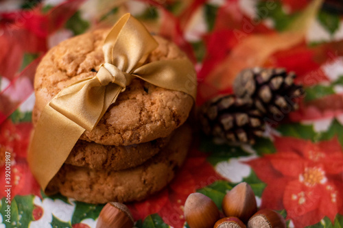 Christmas cookies with gold ribbon, cones and nuts. Festive decoration