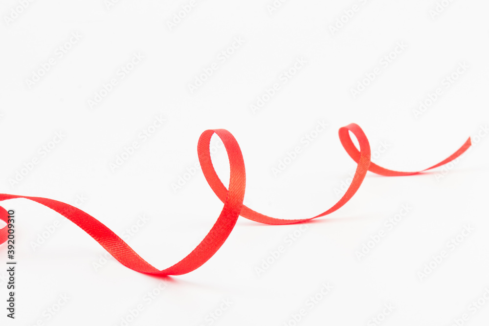 Top view of Red ribbon isolated shiny rolled on white background. Flat lay view. Top view of Red ribbon isolated shiny rolled on white background. Flat lay view.
