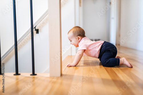 Lonely baby girl in danger close to the stair