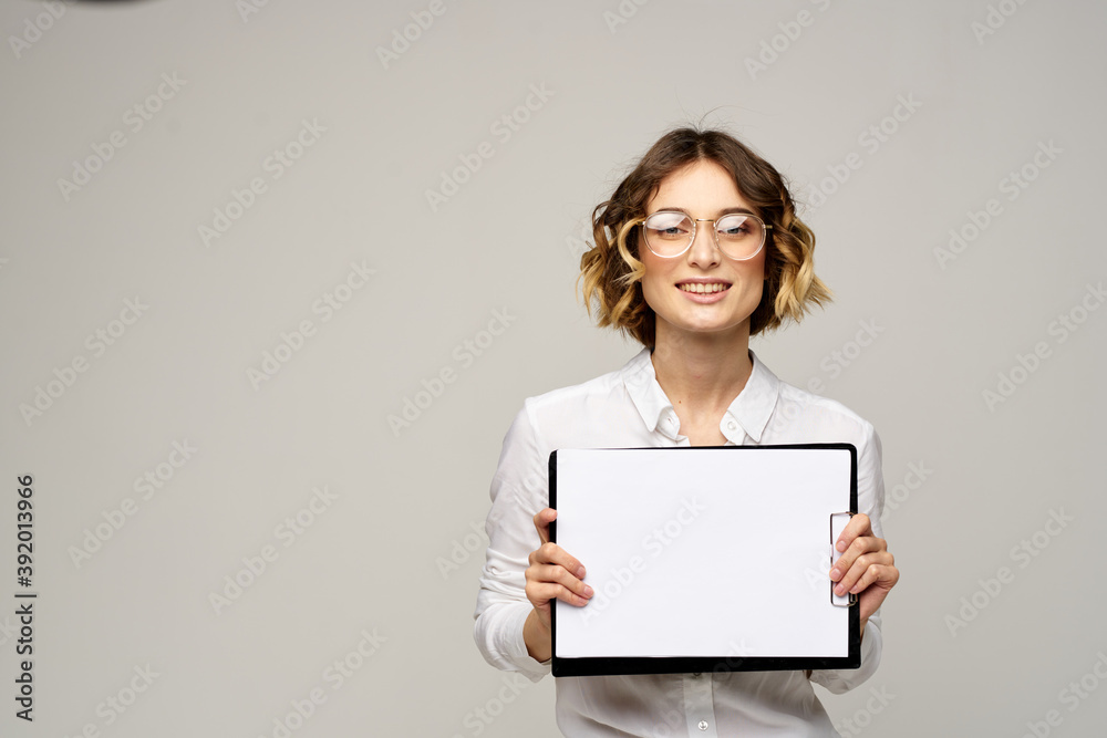 Business woman with a folder of documents on a light background cropped view and shirt suit Business woman with a folder of documents on a light background cropped view and shirt suit