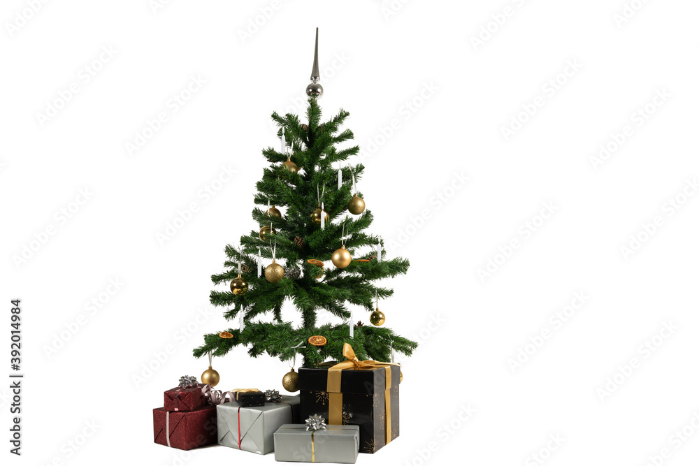 a decorated christmas tree with baubles and candles and gifts underneath a decorated christmas tree with baubles and candles and gifts underneath