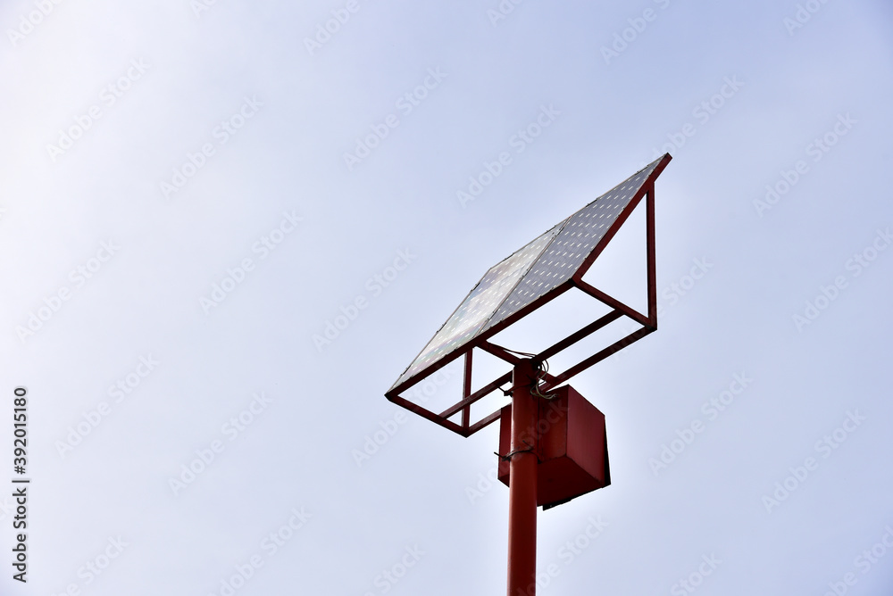 Solar battery on a pole against a blue sky