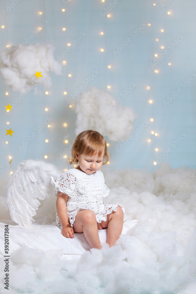baby angel sitting in the clouds looking down baby angel sitting in the clouds looking down